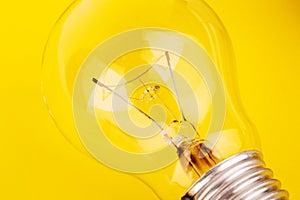 Light bulb lying on yellow background