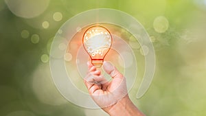 A light bulb in one\'s palm, a notion of inspiration from internet technology, an innovation idea concept, self-learning or