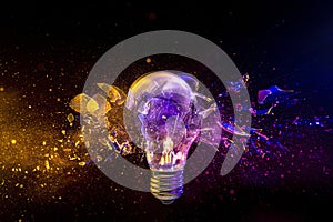 light bulb shattering on black background