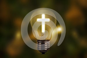 Light bulb with shining cross symbol