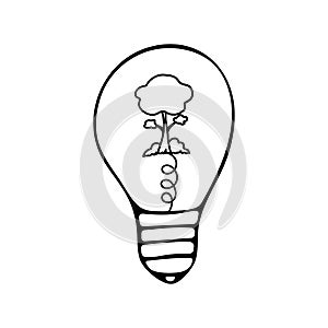 Light bulb with a tree inside and bushes