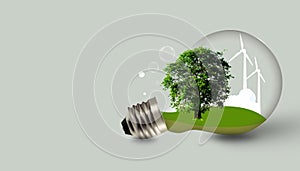 Light bulb with tree and Wind turbines on green background. Energy resources banner