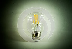 Conceptual light bulb in minimalist white background photo