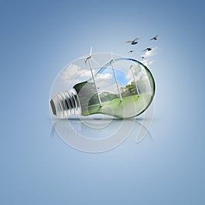 Light bulb with windmill and forest inside, Ecological idea