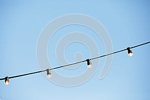 light bulbs against the blue sky.