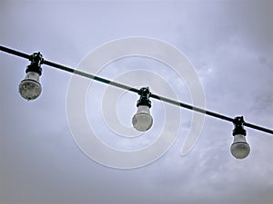 Light Bulbs Against Cloudy Sky on Rainy Day