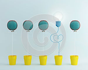 Light bulbs balloon glowing one different idea Cactus balloon other in yellow flower pot on pastel blue background,minimal conce