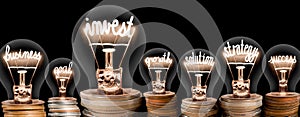 Light Bulbs and Coins with Invest Concept