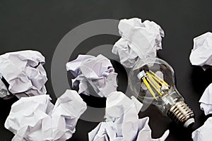 Light bulbs and crumpled paper. Good idea, creativity and inspiration concept.