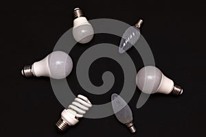 Light bulbs of different types and configurations on a black background. Conventional, diode and energy-saving light bulbs. Place