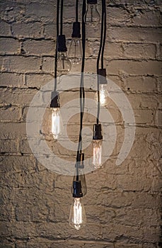 Light bulbs in front of a brick wall.