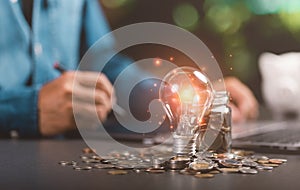 light bulbs, glass jars, coins, all on the table, finance and banking, fund growth and savings concept, saving money for the