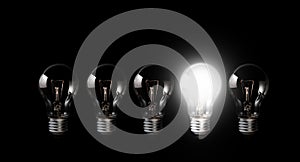 Light bulbs with glowing one outstanding dark background.Business, motivation concept ideas.