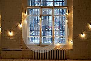 Bulbs hang on long wires on the background of a beige wooden closet inside the room photo