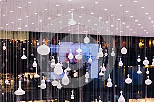 Light bulbs with many forms hang from the ceiling