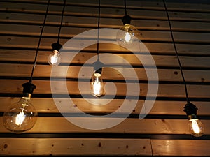 Light bulbs over wooden slats