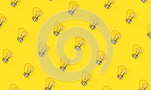 Light bulbs on yellow background in flat lay style