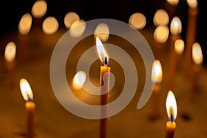 Light from candels in the church on the black background