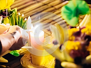 Light the candle by man hand for pray from loykratong festival a
