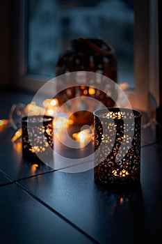 Light chain and candles create a cosy atmosphere. Romantic. Christmas