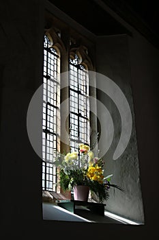 Light through church window with flowers