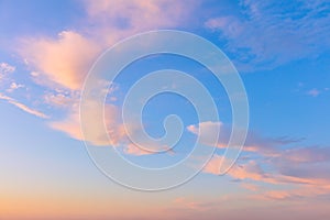 Light cirrus clouds in the blue sky during dawn sunset, real pastel colors