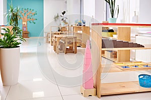 Light class in Montessori kindergarten. The pink tower is in the foreground. nobody