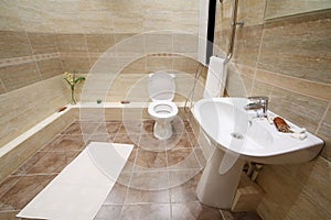 Light and clean toilet with tiles on floor