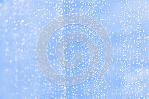 Light cold blue blurred background with water drops pattern
