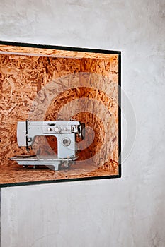 Vintage Sewing machine on flakeboard background