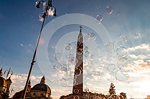 Light and colorful soap bubbles flying with the wind in the air to the sky above Piazza del Popolo