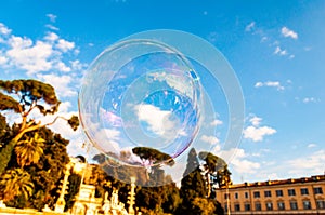 Light and colorful soap bubbles flying with the wind in the air to the sky above Piazza del Popolo