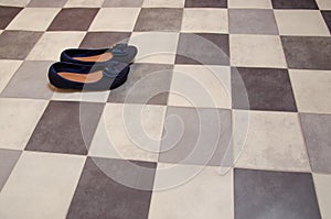 Light and comfortable blue women`s shoes on  black and white checkered floor