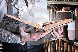 Light coming from old book in woman`s hands. concept of wisdom, reading