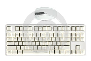 Light computer keyboard and mouse isolated on white background close-up, top view