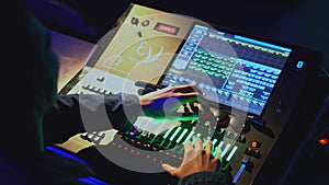 Light console control. Media. Man moves joysticks on light and sound control panel in theater. Modern sound and light