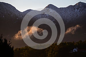 Dawn light illuminates the snowy mountain photo