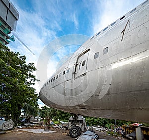 Light Deck of Damage Airplane Being Repair At Outdoor Maintenance Area. Aircraft Being Scrapped and Disassemble in Graveyard or Ju