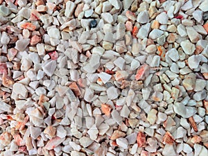 Light decorative stones for the garden in shades of beige, pink and brown. Stone background