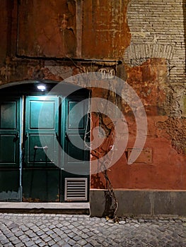 Light door at old building in Rome at night