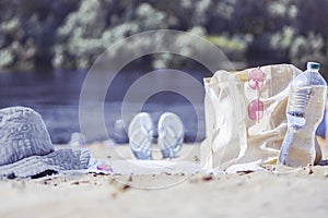 A light eco bag stands on a caved shore