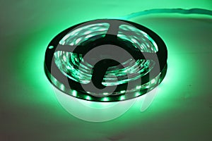 Light emitting diodes or LED strip light in a reel with glowing green color