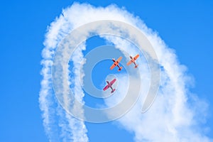 Light engine airplanes perform aerobatics in a cloud of smoke photo