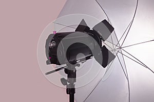 The light equipment of photo studio, on pinkish grey background.