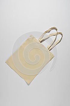 Light fabric eco bag lying on a white background