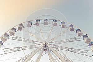 Light ferris wheel without people and piece sunlight. Vintage style. Close-up