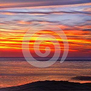 Light fiery sunset on the beautiful and bright ocean horizon