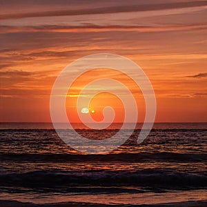 Light fiery sunset on the beautiful and bright ocean horizon