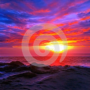 Light fiery sunset on the beautiful and bright ocean horizon