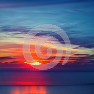 Light fiery sunset on the beautiful and bright ocean horizon